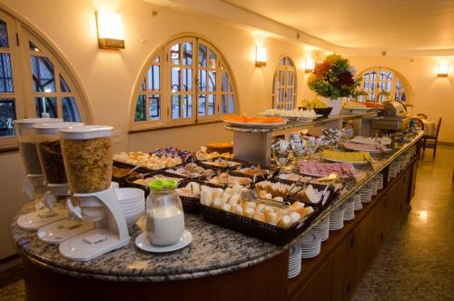 a buffet line with many different types of food at Hotel Monte Alegre in Rio de Janeiro