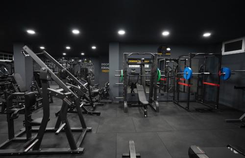 a gym with a lot of equipment in a room at Hotel Arco del Sol in Colmenar