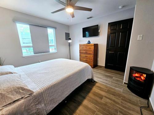 a bedroom with a bed and a fireplace in it at A charming villa with a spectacular pergola and patio in Edinburg