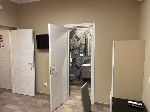 a room with an open door with a mirror at Exclusive B&B in Reggio Calabria
