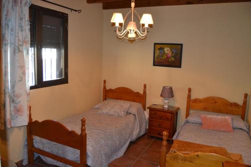 a bedroom with two beds and a window at Cerro del tendero in Fuente del Arco