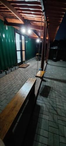 a wooden bench sitting inside of a building at Casa Container em Monte Verde - 800m do Centro in Monte Verde