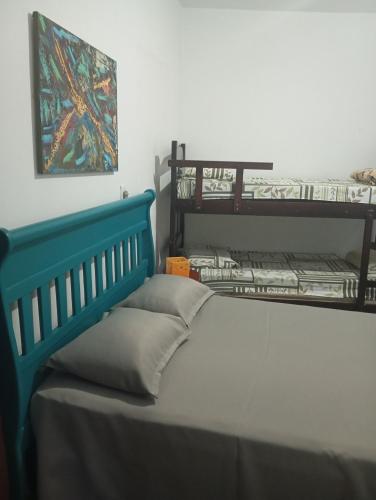 a bedroom with a bed and two bunk beds at Hostel Brasil Gru in Guarulhos