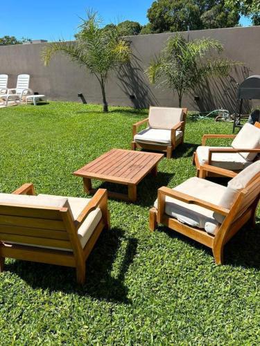 a group of chairs and tables on the grass at La Merced Areco in San Antonio de Areco