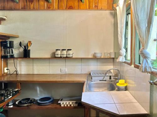 a small kitchen with a sink and a counter at Pachamama Tropical Garden Lodge in Carmen