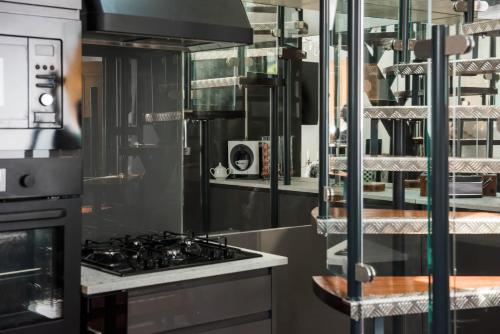 a kitchen with a stove and a microwave at The Penthouse in Kendal