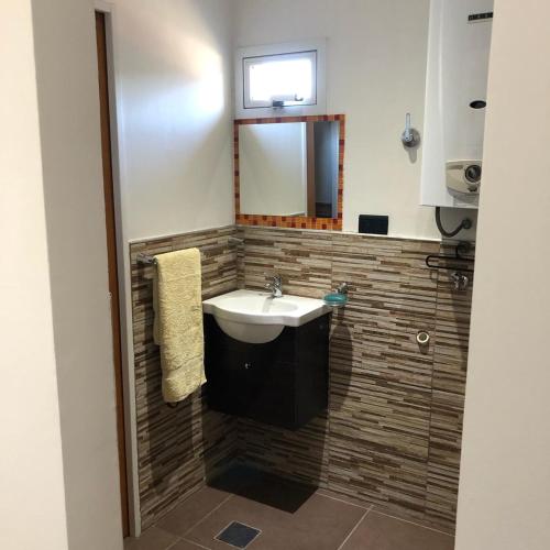 a bathroom with a sink and a mirror at en lo de Pancho 3 in Río Gallegos
