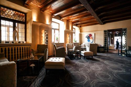 a lobby with couches and chairs in a building at L'auberge Du Cheval Blanc et Spa in Lembach