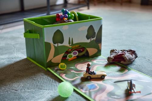 a green box with toys in it on a table at Apartment bei Nürburgring, Parking, Homeoffice in Blankenheim
