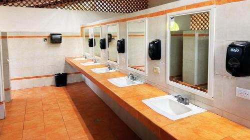 a bathroom with four sinks and a row of mirrors at Exclusive Glamping Resort Puerto Vallarta in Puerto Vallarta