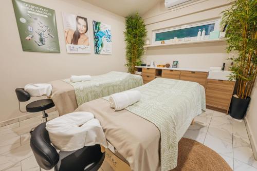a hospital room with two beds and a sink at Eva Spa Resort Rooftop Pool 1br By Lucha in Savaneta