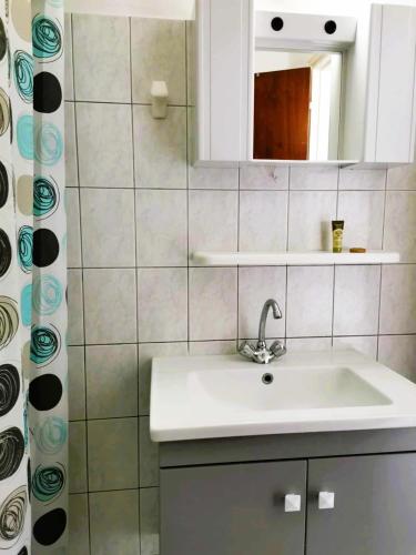 a bathroom with a sink and a mirror at Valentino Studio Kalymnos in Kalymnos
