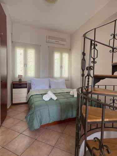 a bedroom with a bed with two towels on it at SyrasView in Ermoupoli