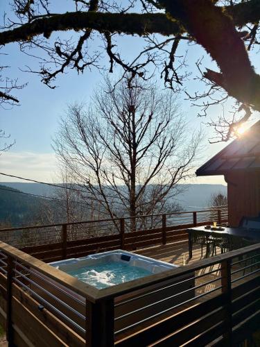 un bain à remous sur la terrasse d'une maison dans l'établissement Chalet Cimebleu SPA & Sauna, à Basse-sur-le-Rupt