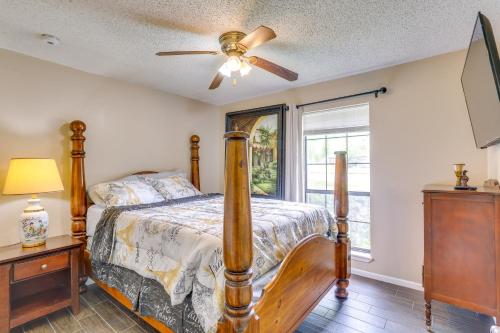 a bedroom with a bed and a ceiling fan at 6 Mi to Ellen Trout Zoo Family Home with Yard! in Lufkin