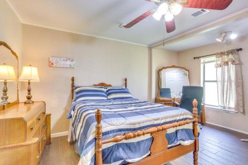 a bedroom with a bed and a dresser and a window at 6 Mi to Ellen Trout Zoo Family Home with Yard! in Lufkin