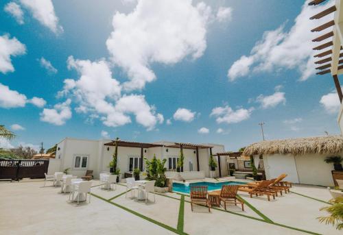 a villa with a swimming pool and a resort at Eva Spa Resort Rooftop Pool 1br By Lucha in Savaneta