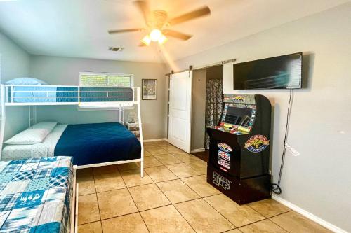 a bedroom with bunk beds and a video game at San Antonio Home with Pool and Hot Tub Near SeaWorld! in San Antonio