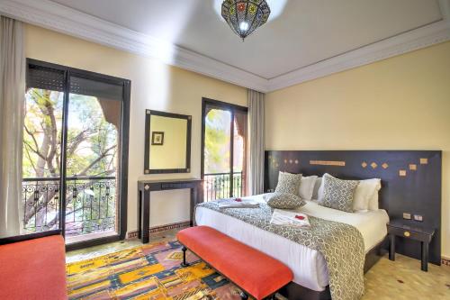 a bedroom with a bed and a large window at VILLA Garden in Marrakesh
