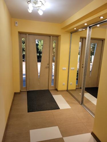 an empty hallway with doors and a rug at Vaido apartamentai in Marijampolė