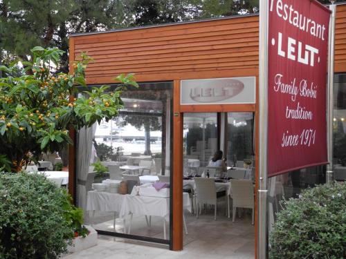 a restaurant with tables and chairs and a sign at Gorgeous apartment Dora in Cavtat