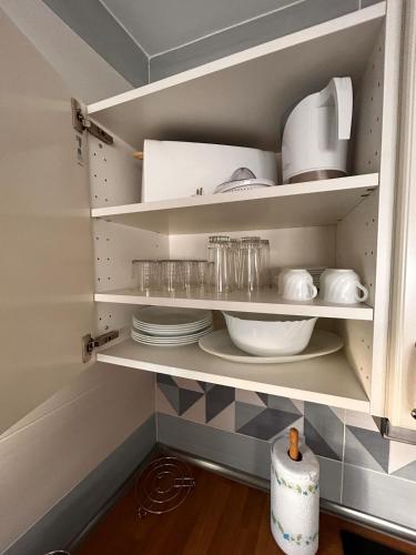 a cupboard filled with plates and dishes in a kitchen at Balcón Néstor Álamo II in Tejeda