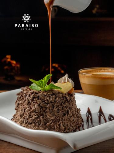 a plate of chocolate dessert with sauce being poured on it at Hoteles Paraiso TRUJILLO in Trujillo