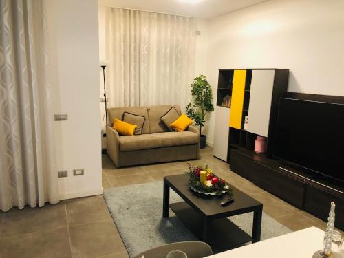 a living room with a couch and a tv at SKY Apartment Pero in Pero