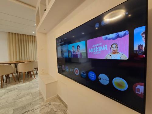 a large flat screen tv hanging on a wall at Le 6éme in Sousse
