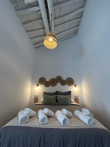 a bedroom with a large bed with towels on it at Casa Peñas 2 in Ronda