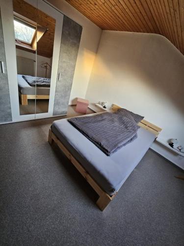 a bedroom with a bed and a large mirror at Vacation Rental Good Times in Friedberg