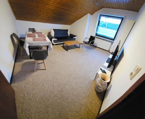 a view of a living room with a table and a couch at Vacation Rental Good Times in Friedberg