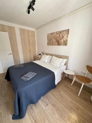 a bedroom with a large bed with a blue blanket at Casa Limon in Cartagena