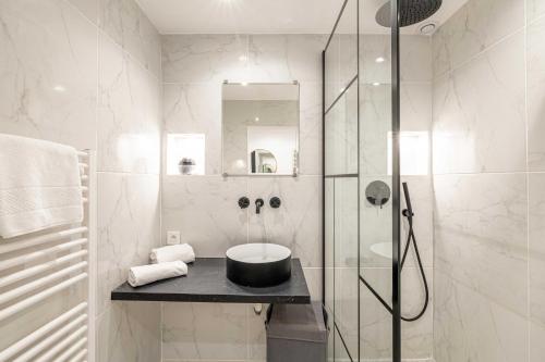 une salle de bain avec une douche en verre et un lavabo dans l'établissement Appartement confort & Sérénité 2BDR 4P, à Cannes