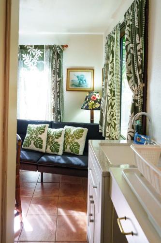 a living room with a couch in front of a window at Lanai Villas in Koloa