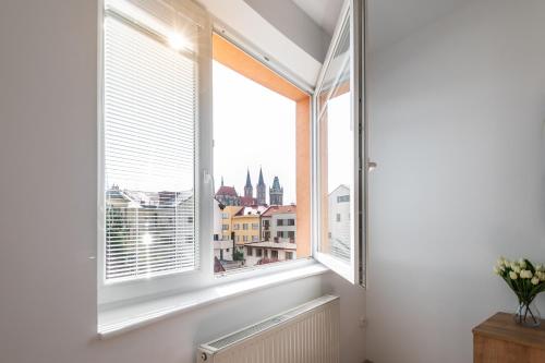 a window with a view of the city at Café Kaftan - pension in Kolín