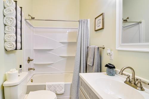 a bathroom with a sink and a toilet and a tub at Cumberland Lake Retreat Furnished Deck and Grill! in Burnside