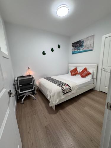 a bedroom with a bed and a desk in it at Sweet home 2 bedroom suite in Surrey