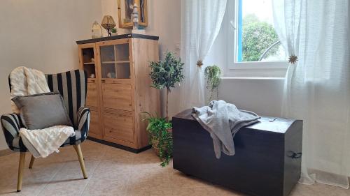 a room with two chairs and a wooden cabinet at Calma di Medulin in Medulin