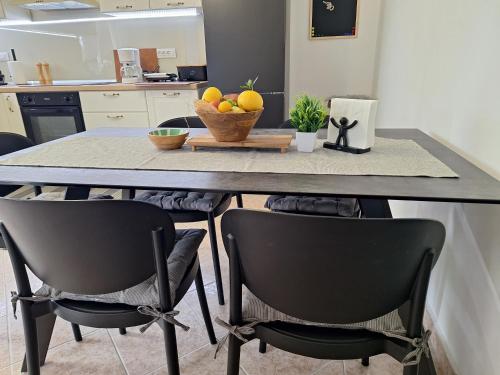 a kitchen with a table with a bowl of fruit on it at Calma di Medulin in Medulin