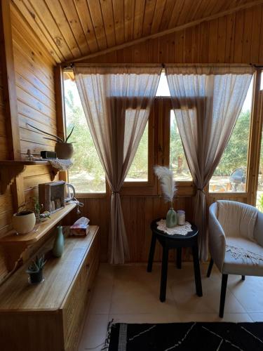 a living room with a table and a window at Meddur Siwa Oasis in Siwa