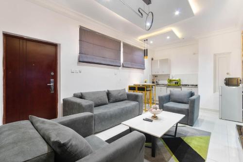 a living room with two couches and a table at 2 bedroom Luxury Shortlet Apartment in Osapa London, Lekki in Lagos
