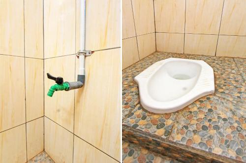 a bathroom with a toilet in a bathroom stall at Hotel O Inn Homestay in Labuan Lombok