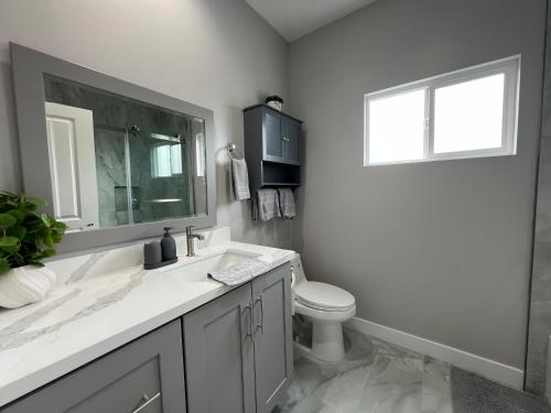 a bathroom with a sink and a toilet and a window at Vacation home in Westminster