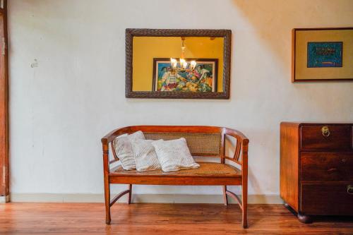 a bench with white pillows on it in a room at OYO 94118 Homestayque Syariah in Cimahi