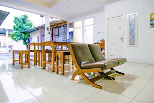 a living room with a chair and a table at OYO 2417 Melati Residence in Blitar
