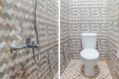 a bathroom with a toilet and a shower at Hotel O Anara Residence & Guest House in Medan