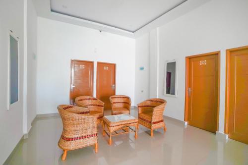 a group of chairs and a table in a room at Hotel O Anara Residence & Guest House in Medan