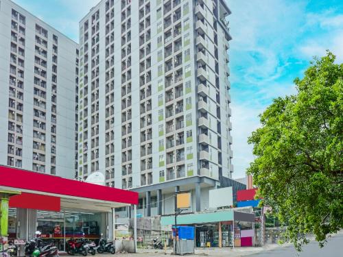 a tall building with a gas station in front of it at OYO Life 93044 Green View Residence in Tangerang