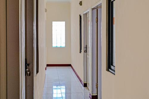 a hallway with two doors and a tile floor at OYO Life 92546 Kost Merah Bojongsoang Syariah in Bandung